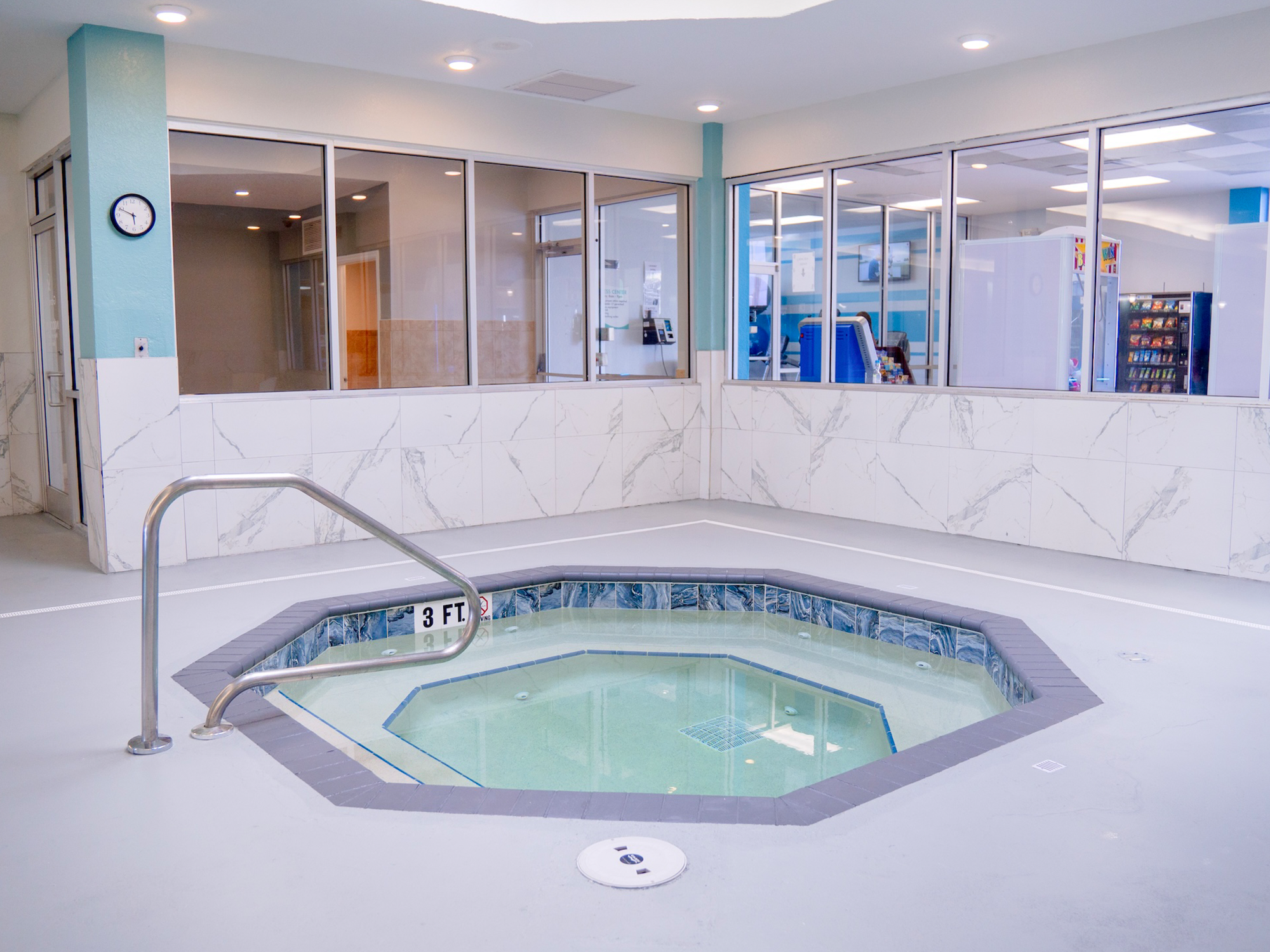Indoor hot tub with tiled interior in a modern building setting