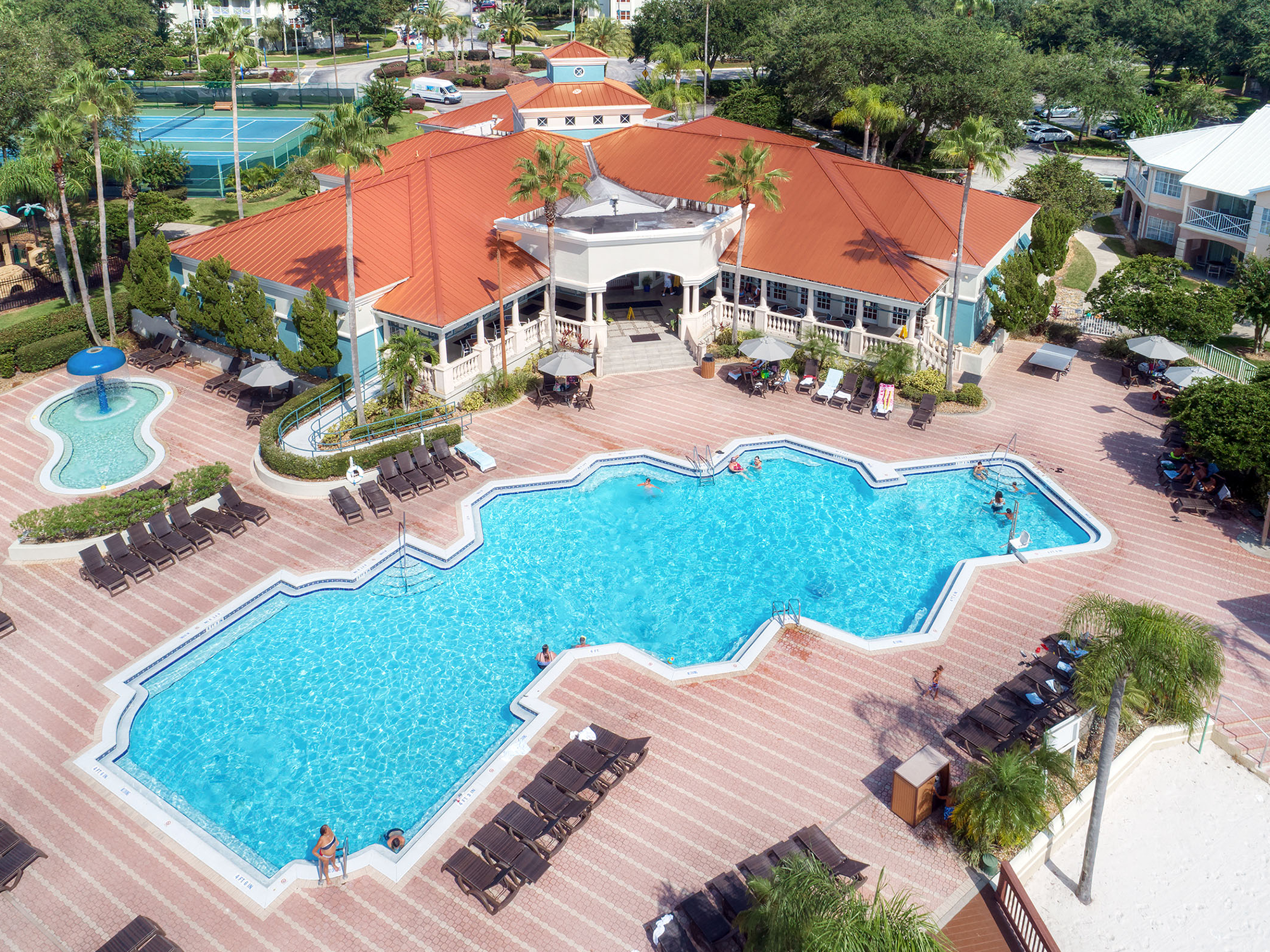 Aerial view of the Summer Bay Orlando Resort with a large pool and lounge chairs